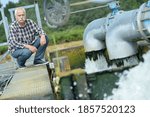 a workman inspecting a dam