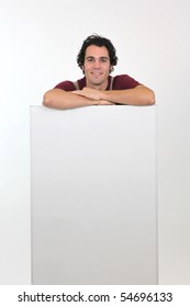 Workman leaning on a panel for message