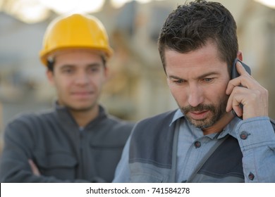 Workman Receiving Worrying Phonecall