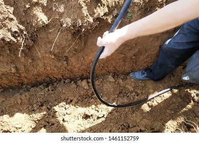 The Workman Will Shield The Electric Cable In The Trench.