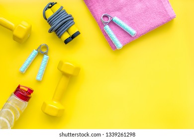 Workout With Bars, Bottle Of Water And Wrist Builder Yellow Background Top View Mockup