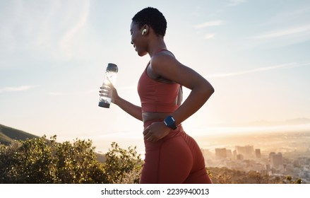 Workout, black woman or sunset with runner training, exercise for wellness, health or hydration. African American female, lady or athlete with water bottle, practice for marathon or fitness in nature - Powered by Shutterstock