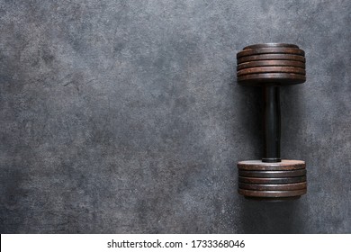 Workout concept background with old dumbbell, home gym concept, sepia toning. - Powered by Shutterstock