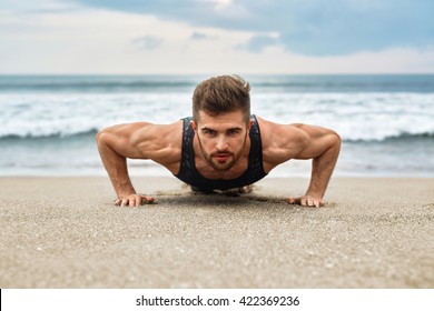 Workout Exercise. Closeup Of Healthy Handsome Active Man With Fit Muscular Body Doing Push Ups Exercises. Sporty Athletic Male Exercising At Beach, Training Outdoor. Sports And Fitness Concept - Powered by Shutterstock