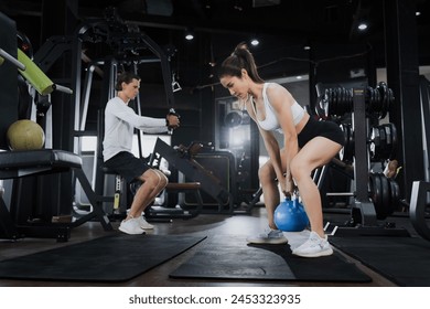 Workout, Fitness workout in gym with trainer assisted in training, Fitness concept, Fit asian woman, Young white man and asian girl exercising in the gym. - Powered by Shutterstock