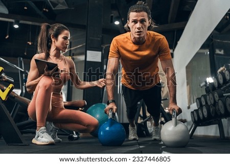 Workout, Fitness workout in gym with trainer assisted in training, Fitness concept, Fit asian woman, Young white man and asian girl exercising in the gym.