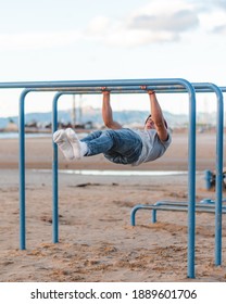 Workout In Front Of The Beach On The Parallel Bars. Front Lever Calisthenics Exercise.