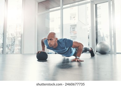 Workout, man and push up in gym for fitness, health and wellness, athlete and training. Exercise, strong and bodybuilder in sport club for body endurance, performance and medicine ball for muscle - Powered by Shutterstock