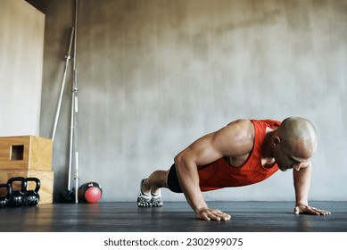 Workout, muscular and man doing gym studio push up for exercise, health performance and sports training for muscle building. Bodybuilding routine, determination or strong person doing floor pushup - Powered by Shutterstock