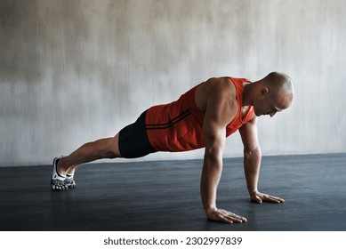 Workout, muscular and man doing push up for exercise, health performance and sports training for muscle building. Bodybuilding mockup, healthy gym body and strong person doing studio floor pushup - Shutterstock ID 2302997839