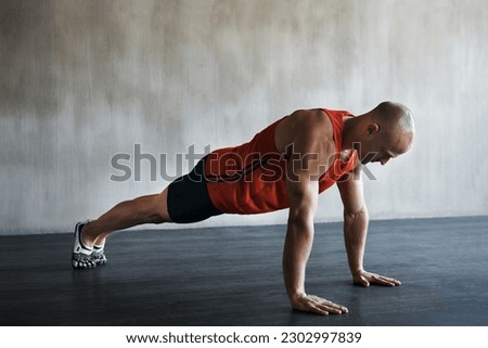 Workout, muscular and man doing push up for exercise, health performance and sports training for muscle building. Bodybuilding mockup, healthy gym body and strong person doing studio floor pushup