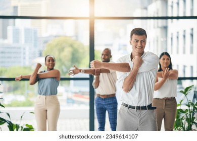 Workout, stretching and a group of business people in the office to exercise for health or mobility together. Fitness, wellness and coach training an employee team in the workplace for a warm up - Powered by Shutterstock