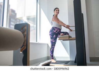 Workout. Young plus size woman exercising in the gym