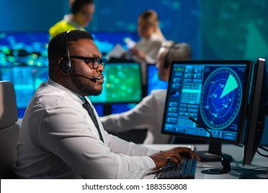 Workplace of the air traffic controllers in the control tower. Diverse team of aircraft control officers works using radar, computer navigation and digital maps. Aviation concept. - Shutterstock ID 1883550808