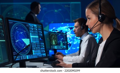 Workplace of the air traffic controllers in the control tower. Team of professional aircraft control officers works using radar, computer navigation and digital maps. Aviation concept. - Shutterstock ID 2202090299