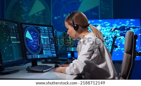 Workplace of the air traffic controllers in the control tower. Team of professional aircraft control officers works using radar, computer navigation and digital maps. Aviation concept.