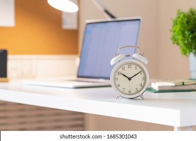 Workplace with alarm clock in modern style. Business communication concept. Home office workplace.