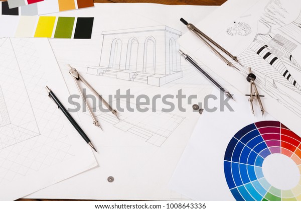 Workplace of architect. Divider, pencil and color\
swatch on blueprint, creating new architectural project on table,\
copy space