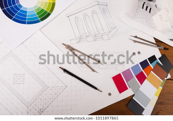 Workplace of architect. Divider, pencil and color\
swatch on blueprint, creating new architectural project on table,\
copy space