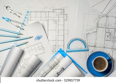 Workplace of architect - Architect rolls and plans.architectural plan,technical project drawing. Engineering tools view from the top. Construction background.
