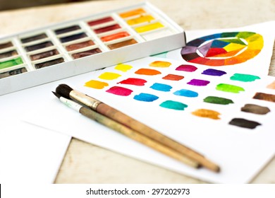 Workplace artist - paper, paint, brushes, color wheel.  - Powered by Shutterstock