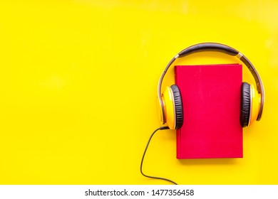 Workplace With Books And Headphones On Yellow Background Flatlay Mockup