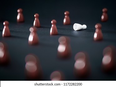 Workplace Bullying, Racism In Society Or Excluding Concept. Prejudice, Peer Pressure, Social Anxiety Or Being An Outcast. Conflict And Stress In Team. One Different Color Game Pawn Fallen On Ground.