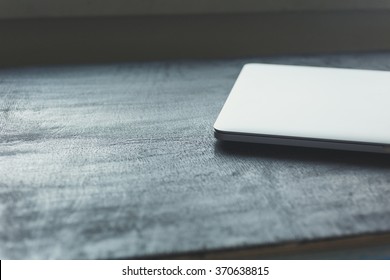 Workplace With Closed Laptop On Black Modern Wooden Desk, Angled Notebook On Table In Home Interior, Filtered Image, Soft Focus