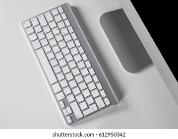 Workplace with computer and wireless keyboard on white background