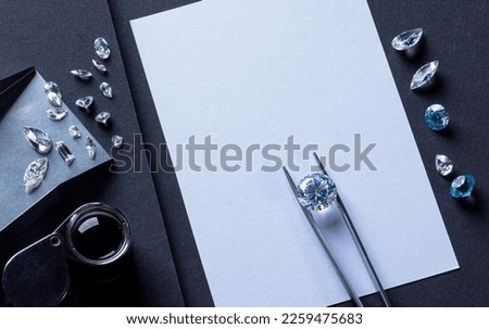 Workplace of diamond expert in process of evaluating diamonds, top view black background.