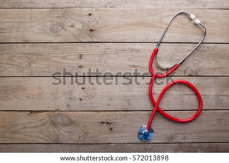 Workplace of a doctor. Stethoscope on the wooden desk