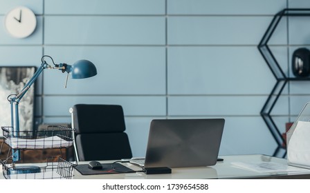 Workplace in empty office. Table with laptop.