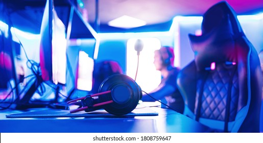 Workplace For Esport Computer Gamer With Blur Pink Neon Light Background.