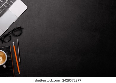 Workplace essentials: Laptop, coffee, notepad and supplies. Flat lay with copy space