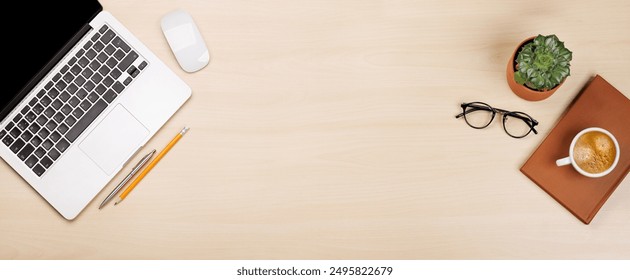 Workplace essentials: Laptop, coffee, notepad and supplies. Flat lay with copy space