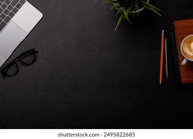 Workplace essentials: Laptop, coffee, notepad and supplies. Flat lay with copy space