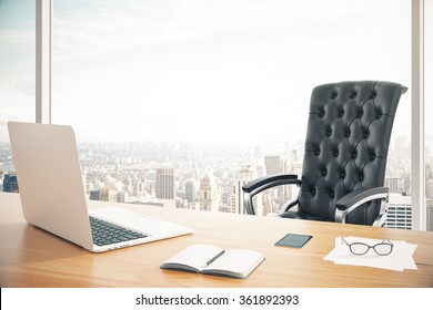 Workplace of the head with a laptop and a classic leather armchair