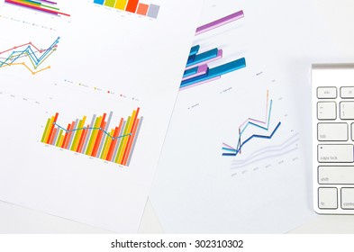 Workplace with keyboard  and graphs