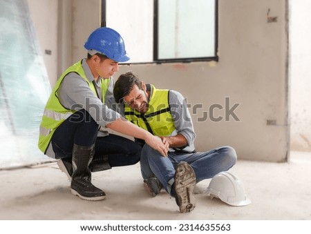 Workplace knee accident of construction worker at site Construction worker accident injured while working . Leg pain Unsafe work concept. Workers help and first aid the injured.