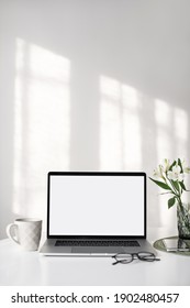 Arbeitsplatz, Laptop-Computer mit leerem, leerem, weißem Bildschirm-Bildschirm auf dem Schreibtisch. Geh nach oben. Heimbüro-Konzept