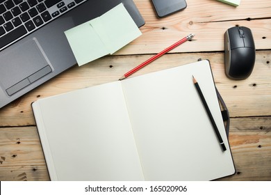 Workplace, laptop and notepad on wooden table - Powered by Shutterstock