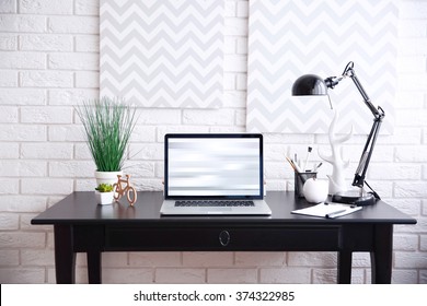 Workplace with laptop on table at home