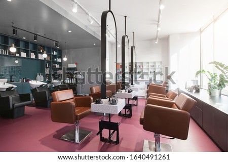 Workplace makeup artist and hairdresser. Nobody. Big mirrors and leather chairs, beauty salon interior