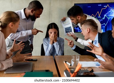 Workplace Mobbing. Asian Female Suffering Bullying From Colleagues In Office, Group Of Agressive Coworkers Shouting At Stressed Employee Woman During Corporate Meeting In Boardroom, Closeup - Shutterstock ID 2100694402