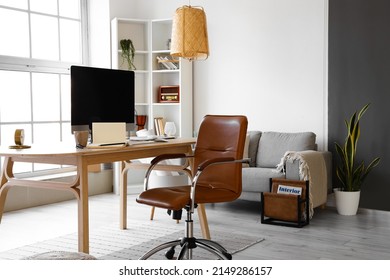 Workplace with modern computer in light room interior