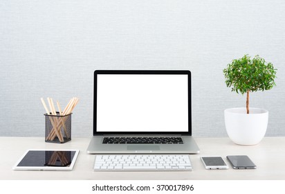Workplace with modern gadgets. Laptop on a table with blank screen