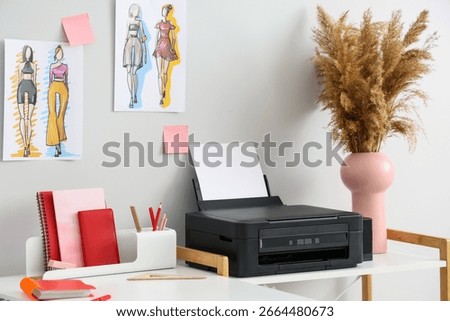 Workplace with modern printer in light clothes stylist home office