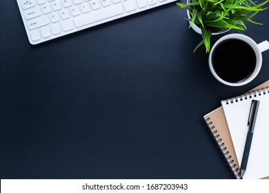 Workplace In Office With Black Desk. Top View From Above Of Keyboard With Notebook And Coffee. Space For Modern Creative Work Of Designer. Flat Lay With Blank Copy Space. Business And Finance Concept.