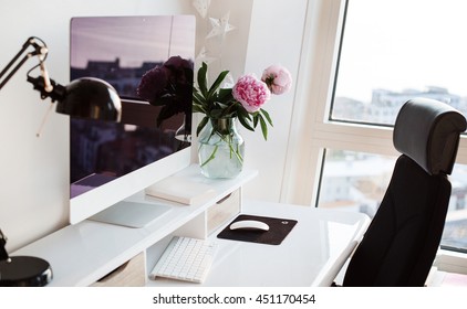 Workplace. Office. Scandinavian Interior. Presentation Template. Flowers, Keyboard, Computer, Desk, Desk Lamp. Pink Peonies In Vase. White Desk. Home Office Interior. View From Window.