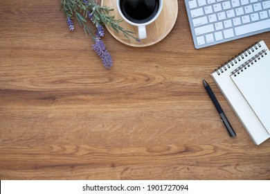 Workplace In Office With Wooden Desk. Top View Above Of Keyboard Computer With Notebook And Pen. Space For Modern Creative Work Of Designer. Flat Lay With Copy Space. Business-finance Concept.